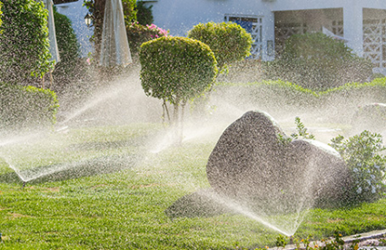 An irrigation system watering a lush lawn.