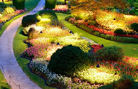 Residential flower bed along a lighted stone path.