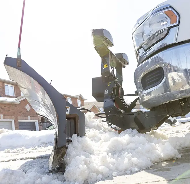 The side of a snow plow attachment on a Grounds Guys truck as it plows snow.