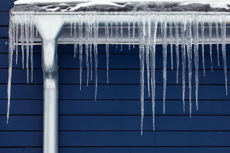 Icicles hanging from a gutter on a roof