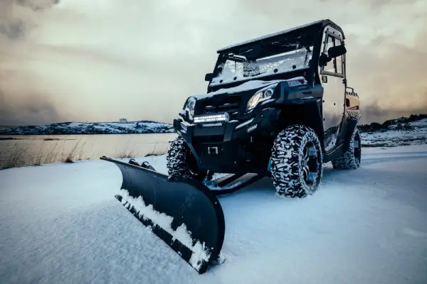 Snow plow connected to an ATV.