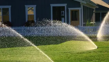 Irrigation system watering a residential lawn.