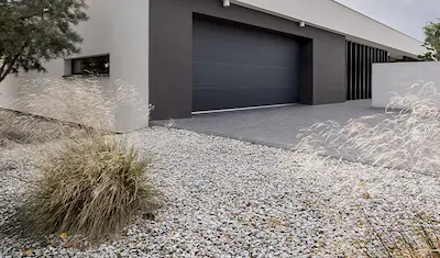 garage and driveway with decorative stone