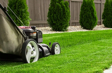 grounds guys landscaper mowing a residential lawn in winnipeg