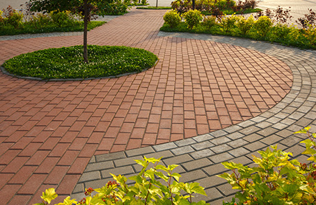 brick paver path surrounded by neat mulch beds
