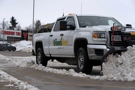 Grounds guys truck with snowplow.