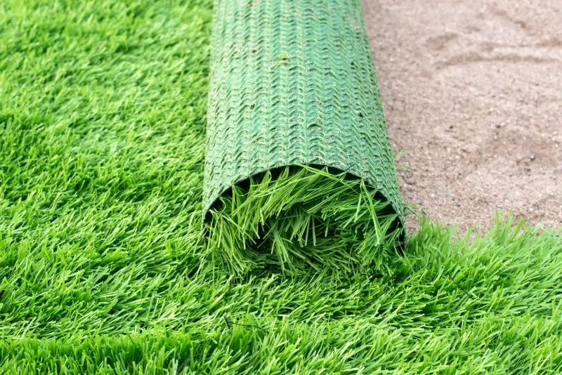 A roll of artificial turf on a commercial property.