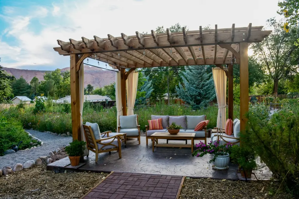 Residential backyard seating area under a pergola